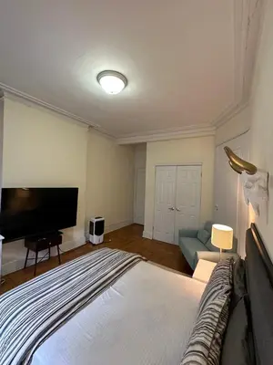 a bedroom with a bed and a flat screen tv at TIME SQUARE 42nd Street Private Room in New York