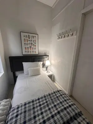 a bedroom with a bed with a checkered blanket at TIME SQUARE 42nd Street Private Room in New York