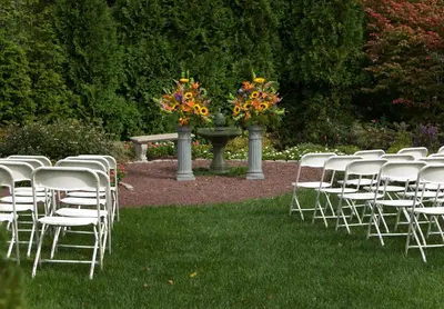 a row of chairs with flowers in a garden at General Warren in Malvern
