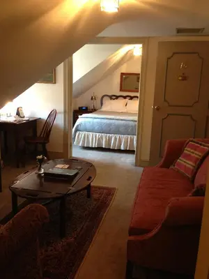 a bedroom with a bed and a table and a couch at General Warren in Malvern