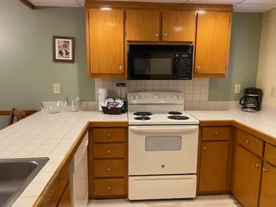 a kitchen with a white stove and a microwave at Pocono Villas Resort in East Stroudsburg
