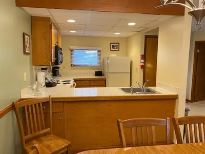 a kitchen with a counter and a sink and a refrigerator at Pocono Villas Resort in East Stroudsburg