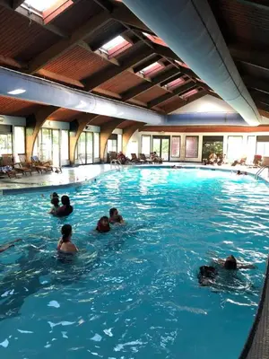 a group of people swimming in a swimming pool at Pocono Villas Resort in East Stroudsburg