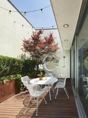 a patio with a table and chairs on a deck at The Maritime Hotel in New York
