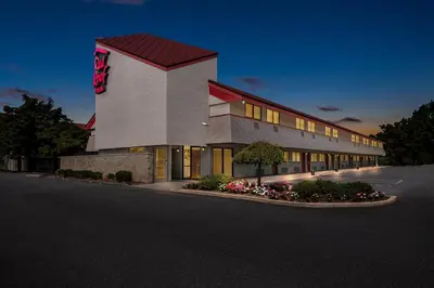 a front view of a hotel at night at Red Roof Inn Harrisburg North in Harrisburg