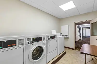 a laundry room with a washer and dryer at Days Inn by Wyndham Liberty in Ferndale