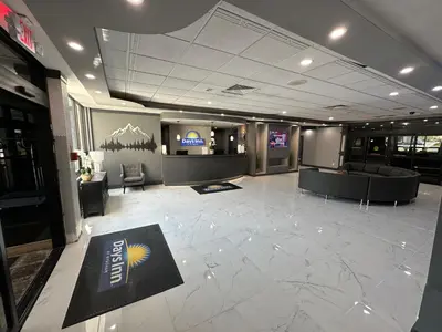 a lobby of a building with a sign on the floor at Days Inn by Wyndham Liberty in Ferndale