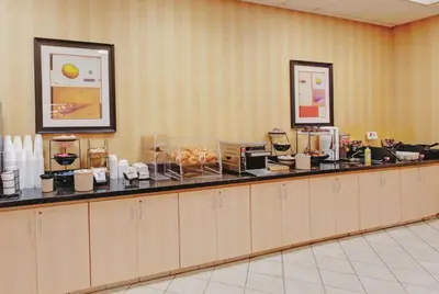 a buffet line in a hotel room with food at Ramada Inn by Wyndham Fairfield NJ in Fairfield