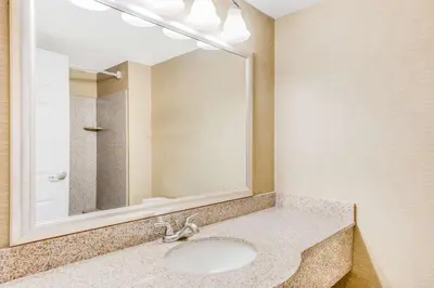 a bathroom with a sink and a mirror at Wingate by Wyndham - York in York