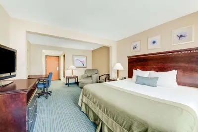 a hotel room with a bed and a flat screen tv at Wingate by Wyndham - York in York