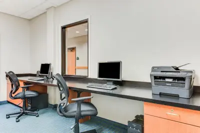 an office with a desk with a computer and two chairs at Wingate by Wyndham - York in York