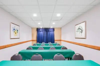 a conference room with green tables and chairs at Wingate by Wyndham - York in York