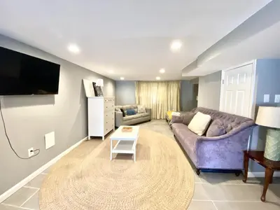 a living room with a couch and a table at Tuscany 2900 - Classic Italian Style 3BR w Parking near Airport in Philadelphia