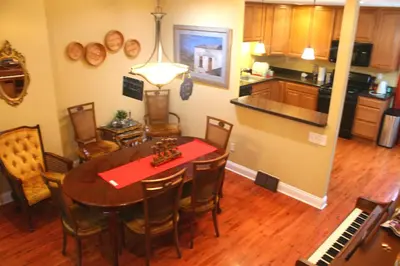 a kitchen and dining room with a table and a piano at Tuscany 2900 - Classic Italian Style 3BR w Parking near Airport in Philadelphia