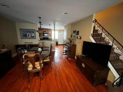 a living room with a table and a dining room at Tuscany 2900 - Classic Italian Style 3BR w Parking near Airport in Philadelphia