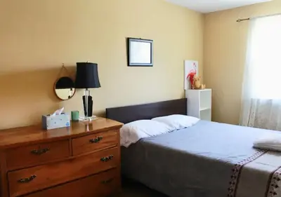 a bedroom with a bed and a dresser at Tuscany 2900 - Classic Italian Style 3BR w Parking near Airport in Philadelphia