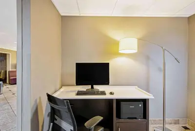 a desk with a computer on top of it at La Quinta by Wyndham Harrisburg Airport Hershey in Harrisburg