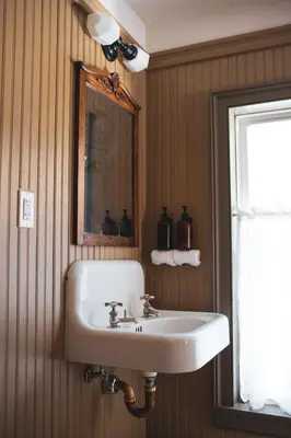 a bathroom with a sink and a mirror and a window at Stonehill's Farmhouse in Accord