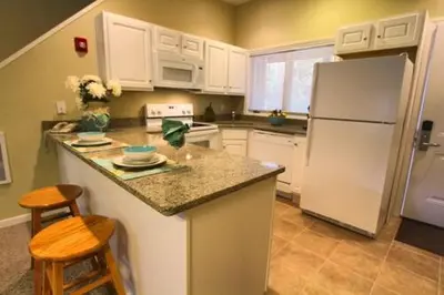 a kitchen with a white refrigerator and a counter top at Tanglwood Resort in Hawley