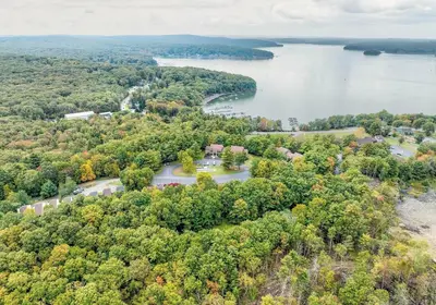 an aerial view of a lake with trees at Tanglwood Resort in Hawley