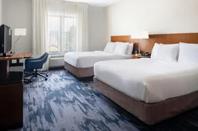 a hotel room with two beds and a television at Fairfield Inn & Suites by Marriott Towanda Wysox in Towanda