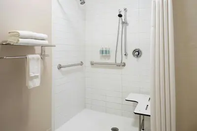 a bathroom with a shower with a shower curtain at Fairfield Inn & Suites by Marriott Towanda Wysox in Towanda