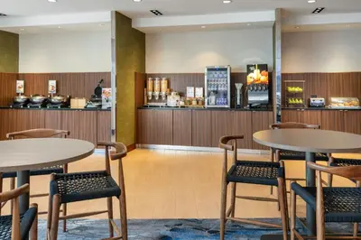 a restaurant with two tables and chairs and a counter at Fairfield Inn & Suites by Marriott Towanda Wysox in Towanda
