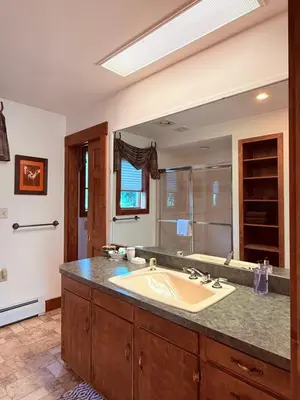 a bathroom with a sink and a large mirror at HIllside Farm B & B in Mount Joy
