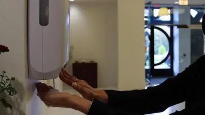 a woman putting her feet in a light on a wall at YO1 Longevity & Health Resorts, Catskills in Monticello