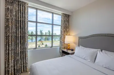 a bedroom with a bed and a large window at YO1 Longevity & Health Resorts, Catskills in Monticello