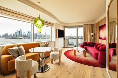 a living room with a red couch and a table at W Hoboken in Hoboken