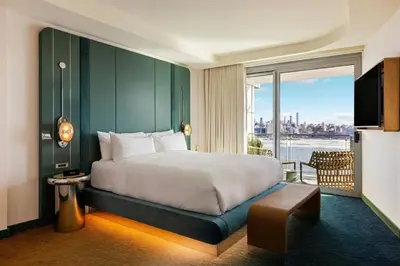 a bedroom with a large bed and a large window at W Hoboken in Hoboken
