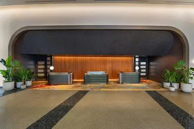 a lobby with chairs and plants in a building at W Hoboken in Hoboken