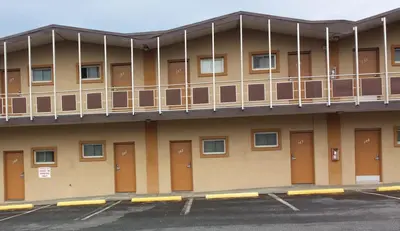 an empty parking lot in front of a building at Hallmark Motel in Cinnaminson