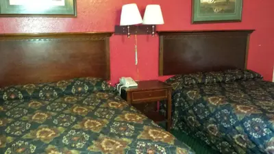 a hotel room with two beds and a telephone at Hallmark Motel in Cinnaminson