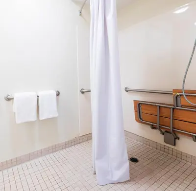 a white shower curtain in a bathroom with towels at Red Roof Inn Edison in Edison