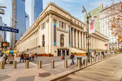 a building in a city with people walking on a street at West 30th Street Guest House in New York