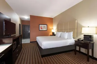 a hotel room with a bed and a flat screen tv at La Quinta by Wyndham Harrisburg-Hershey in Harrisburg