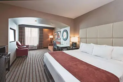 a hotel room with a large bed and a desk at La Quinta by Wyndham Harrisburg-Hershey in Harrisburg