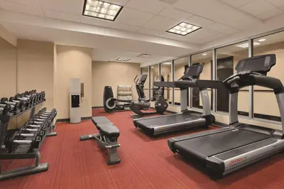 a gym with several treadmills and cardio machines at Hyatt Place New York/Midtown-South in New York