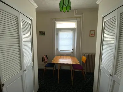 a table in a room with two chairs and a window at Fort Pl B&B and Gallery in Staten Island