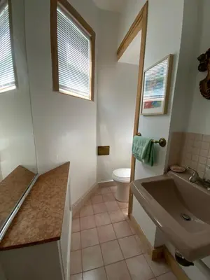 a bathroom with a sink and a toilet at Fort Pl B&B and Gallery in Staten Island
