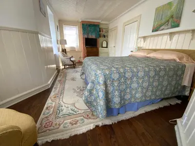 a bedroom with a bed and a rug at Fort Pl B&B and Gallery in Staten Island