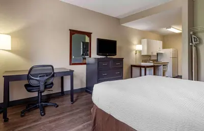 a hotel room with a bed and a desk and a chair at Extended Stay America Suites - Edison - Raritan Center in Edison