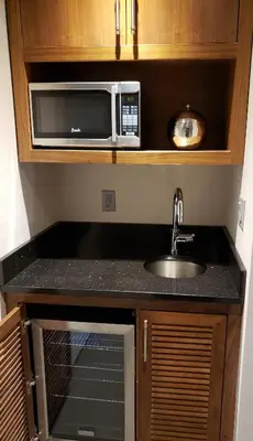 a kitchen with a sink and a microwave at The Belvedere Hotel in New York