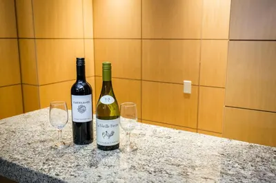 two bottles of wine sitting on a counter with two glasses at The Belvedere Hotel in New York