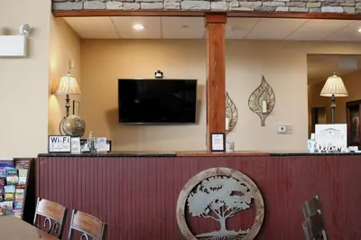 a bar in a restaurant with a flat screen tv at The Lodge at Woodstone Country Club in Danielsville