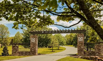 a gate with a sign that reads woodstoppers at The Lodge at Woodstone Country Club in Danielsville