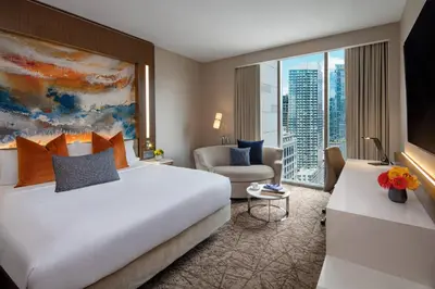 a hotel room with a large bed and a chair at Courtyard New York Manhattan/Midtown West in New York
