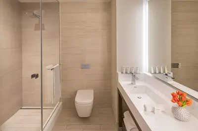 a bathroom with a toilet sink and a shower at Courtyard New York Manhattan/Midtown West in New York